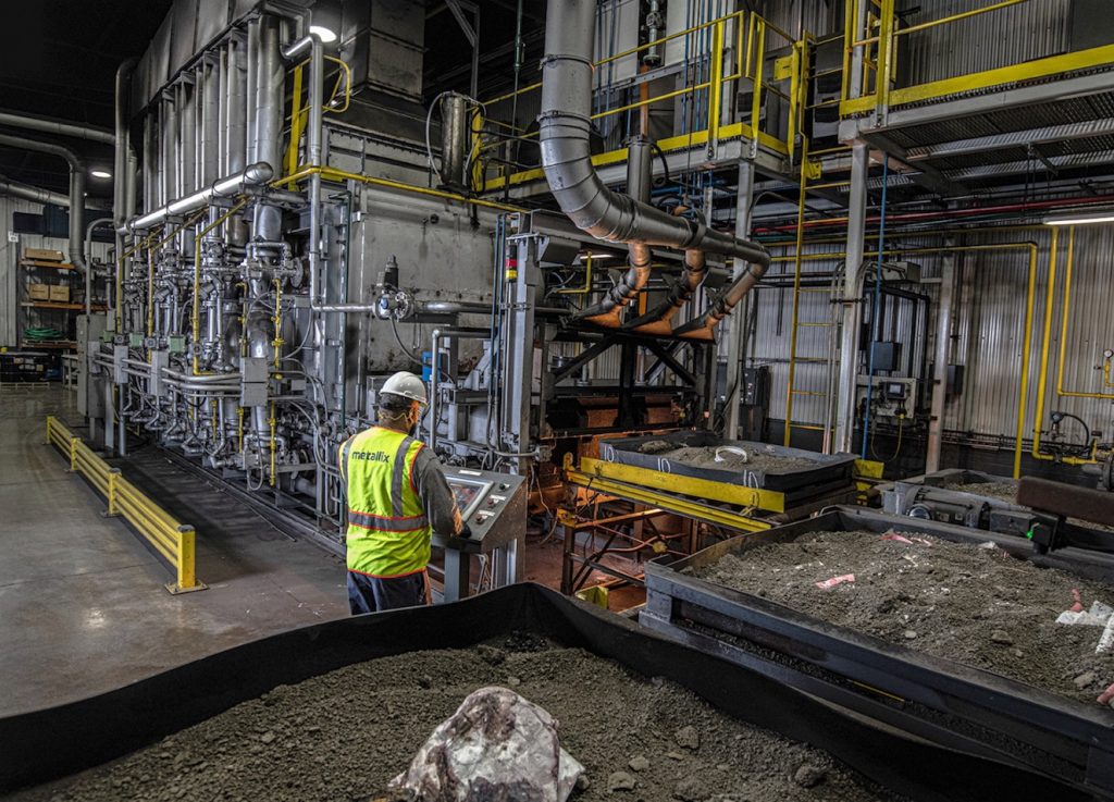 Man working at a precious metals refining plant.